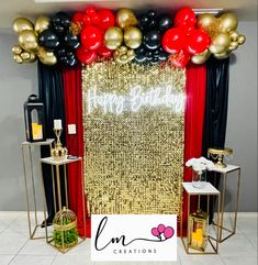 a red and gold birthday party with balloons, streamers, candles and decorations on the wall