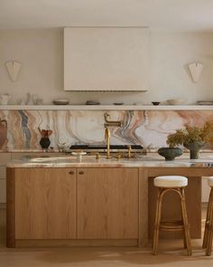 a kitchen with marble counter tops and wooden stools