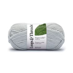 yarn ball with green leaves on the top and bottom, in grey color for knitting