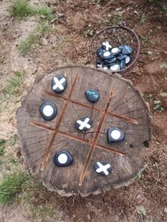 a wooden table topped with rocks and crosses