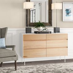 a living room with a chair, mirror and dresser