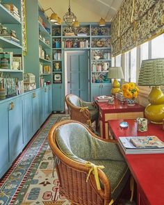 a living room filled with furniture and lots of books