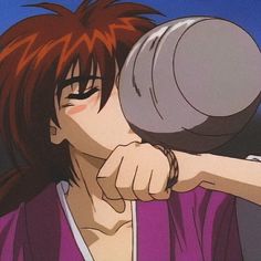 a man with red hair is drinking from a cup