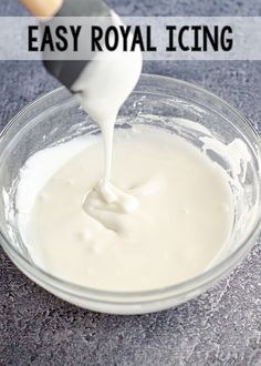 a glass bowl filled with white liquid and the words easy royal icing on it