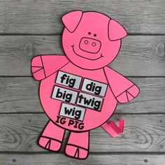 a pink pig cut out with words on it