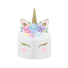 a white cake topped with a unicorn's face and flowers