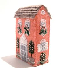 a small doll house made out of felt