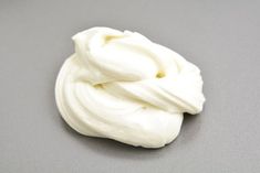 a white whipped cream on a gray surface