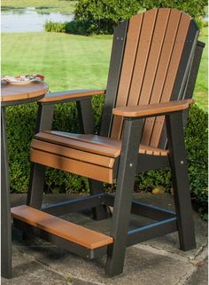 two wooden chairs sitting next to each other near a table with food on top of it