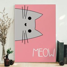 a pink canvas with a cat's face and the word meow on it