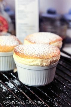 two powdered sugar covered muffins sitting on top of an oven rack next to each other