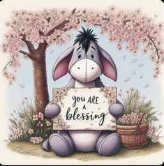 a cartoon donkey holding a sign that says you are a blessing in front of a tree