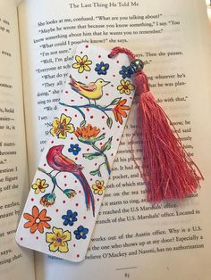 the bookmark is decorated with flowers and birds