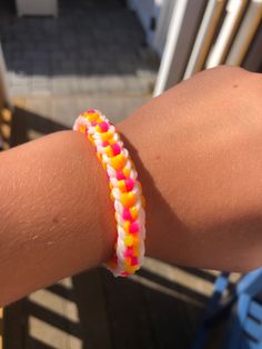 a person's arm with a colorful bracelet on it