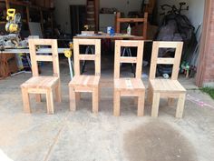 three wooden chairs sitting next to each other in front of a table and chair set