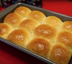 a pan filled with rolls sitting on top of a red table