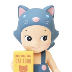 a cat figurine is holding a box with the word cat food on it