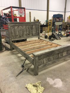 a bed frame made out of wood in a garage