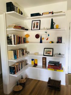 the bookshelves are filled with many different types of books and pictures on them