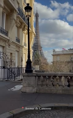 the eiffel tower towering over the city of paris, from across the street