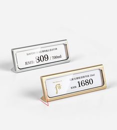 two silver and gold business cards with chinese writing