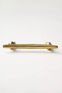 a gold tie bar on a white background