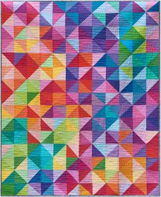 a multicolored quilt on the ground