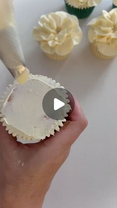 cupcakes being frosted with white icing