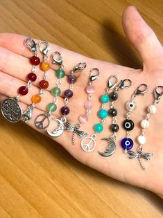 a person's hand with many charms on it