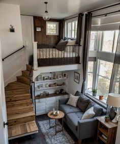 a living room filled with furniture and lots of windows