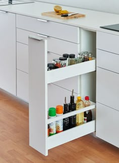 an open cabinet in the middle of a kitchen with spices and condiments on it