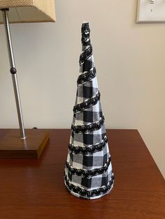 Wire cone embellished with black and white fabric and trim. Decorative Use Only. Dimensions Approx. 4 x 12 inches. (#12) Embellished Fabric, Cone Trees, Black And White Fabric, Key To My Heart, Pumpkin Decorating, Tree Decor, White Fabric, Table Top Decor, White Fabrics