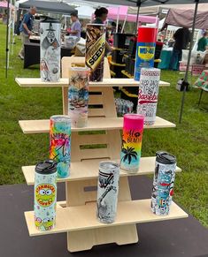 several different types of cups on display under a tent