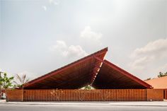 a large wooden structure sitting on the side of a road next to a parking lot