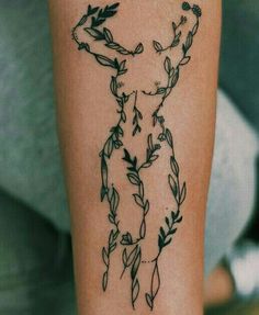 a person with a tattoo on their arm that has vines and leaves all over it