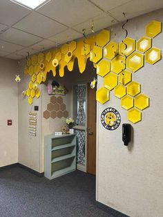 an office decorated with yellow honeycombs hanging from the ceiling and on the wall