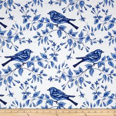 a blue and white bird print fabric with leaves on the side, in front of a ruler