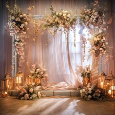 a bed covered in flowers and candles next to a window with curtains on it's sides