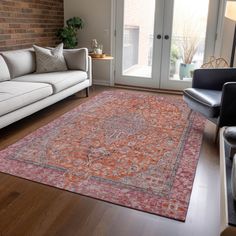 a living room with couches, chairs and a rug