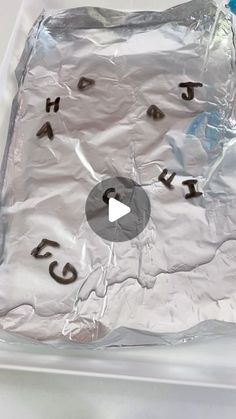 a piece of tin foil with writing on it