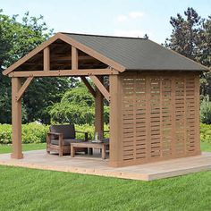 a wooden gazebo sitting on top of a lush green field