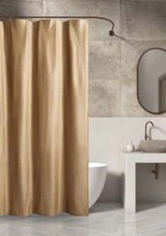 a beige shower curtain in a bathroom next to a white sink and mirror on the wall