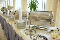 a buffet set up with plates and silverware