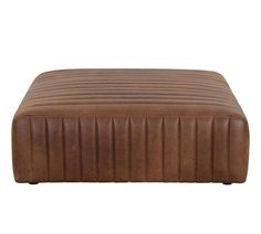 a large brown leather ottoman sitting on top of a white floor