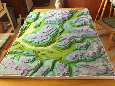 a large sheet cake sitting on top of a wooden table covered in frosted icing