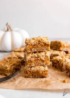 several pieces of granola bars stacked on top of each other next to a fork