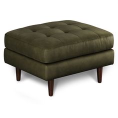 a green ottoman with wooden legs on a white background