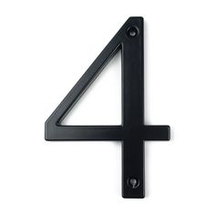 the number four is made out of black metal and sits on a white surface with no one around it