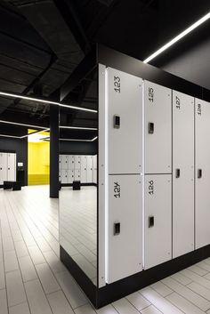 a row of white lockers sitting inside of a building