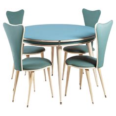 a blue table with four chairs and a round dining room table set on top of it